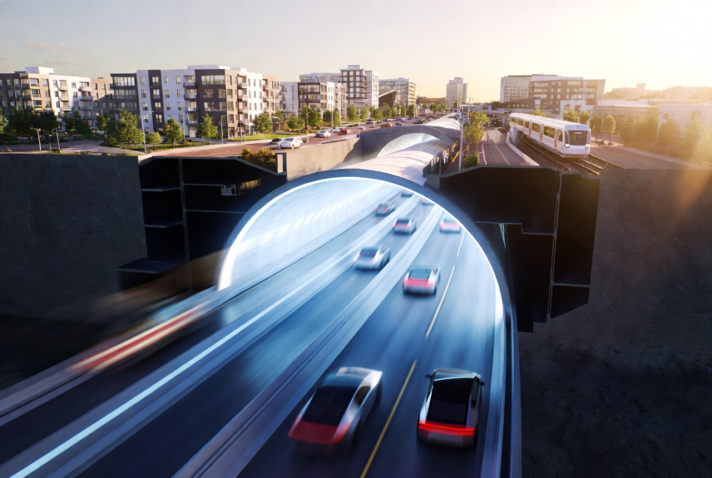 一幅数字渲染的图像显示，夕阳西下，汽车驶过城市地下一条灯火通明的隧道，隧道内有现代建筑、树木和一列在地面上行驶的轻轨列车。.